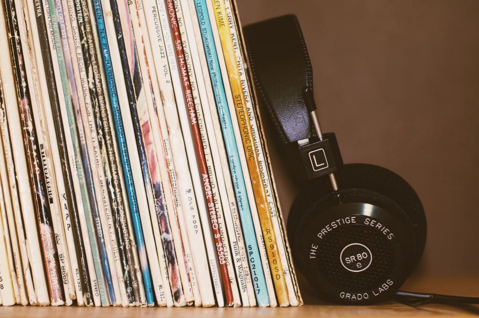 Free Image of Stack of Records and Headphones on Table 