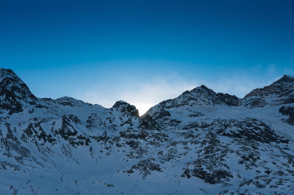 Free Image of Snow-Covered Mountain Range Under Blue Sky 