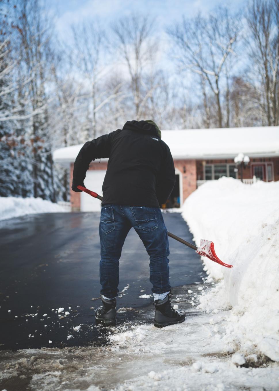 Free Image of Man Shoveling Snow With a Shovel 