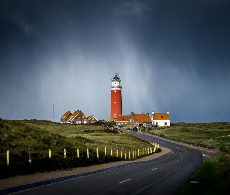 Free Image of Red and White Lighthouse by Roadside 