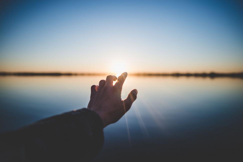 Free Image of Person Raising Hand to Sun 