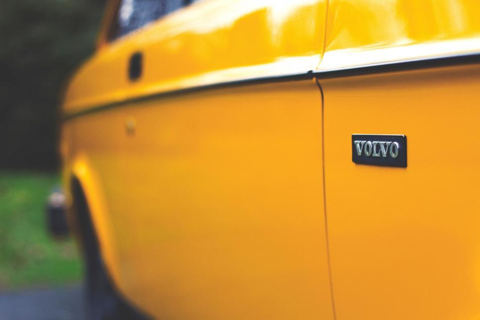 Free Image of Close Up of a Yellow Car With Tag 