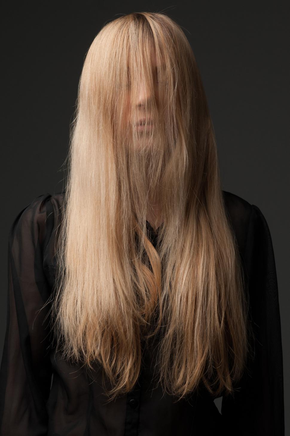 Free Image of Woman With Long Blonde Hair in Front of Black Background 
