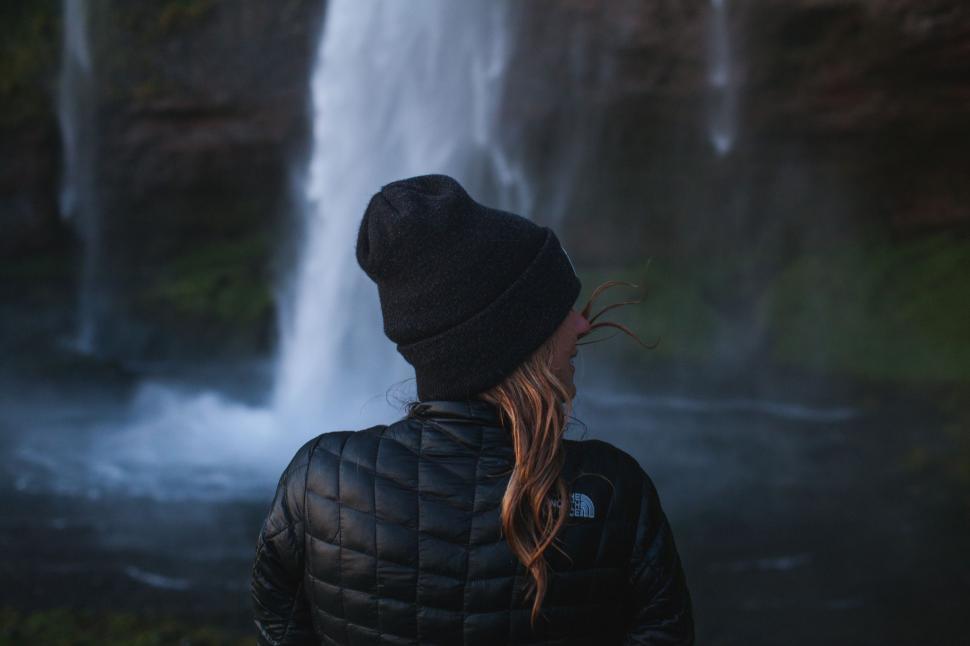 Free Image of Person Standing in Front of Waterfall 