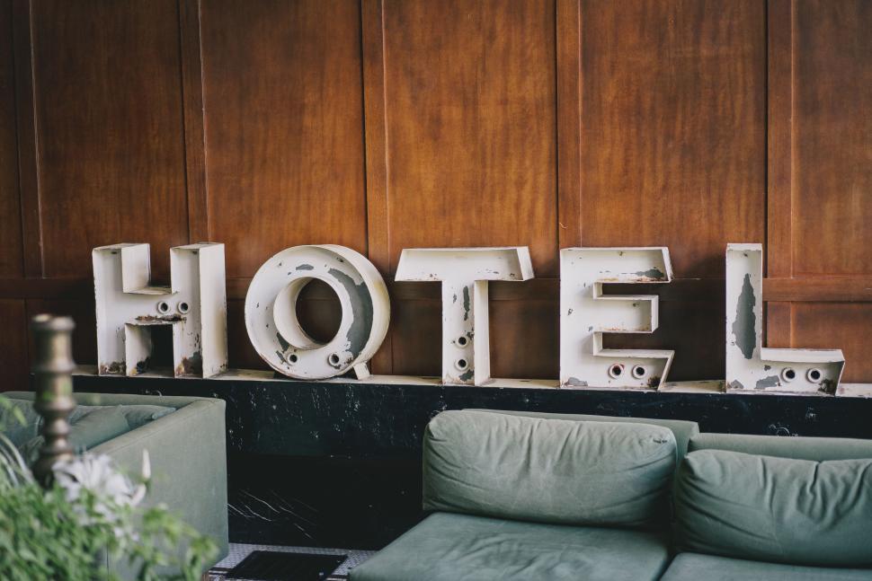 Free Image of Hotel Room With Couches and Hotel Sign 