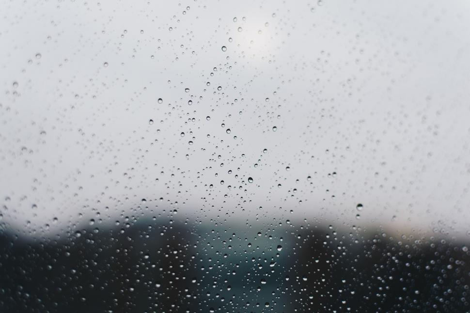 Free Image of Rain Drops on a Window With Black and White Background 