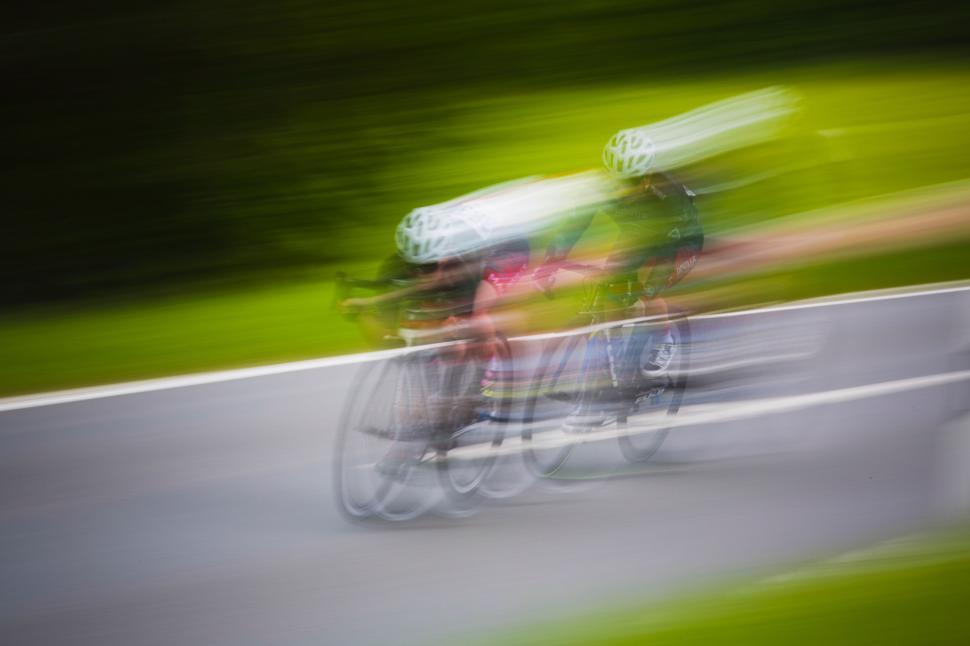 Free Image of Blurry Photo of Two People Riding a Bike 