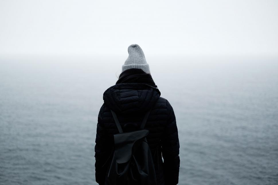 Free Image of Person With Backpack Looking Out at Water 