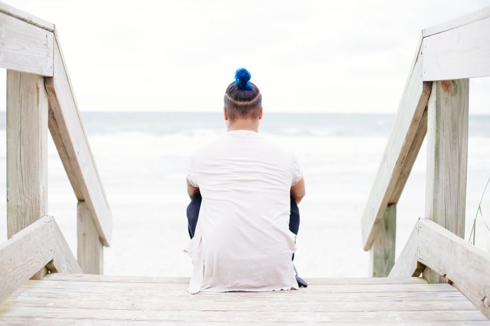 Free Image of Person Sitting on Dock Looking at Ocean 