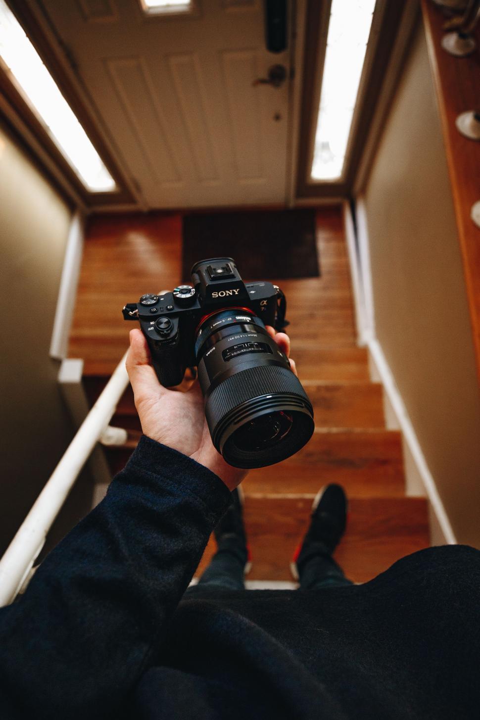 Free Image of Person Holding Camera Up Stairs 
