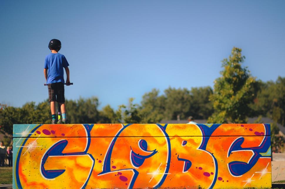 Free Image of Young Man Skateboarding on Graffiti Covered Wall 