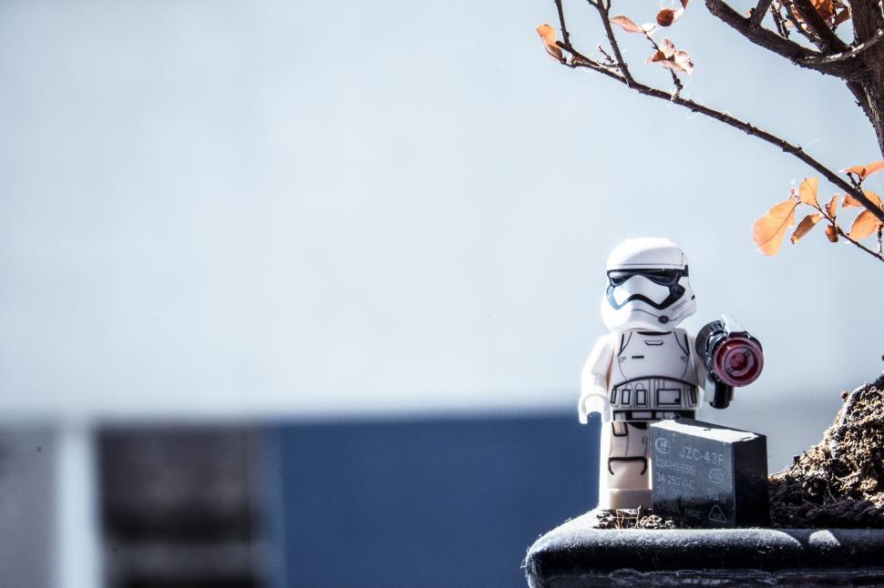 Free Image of Lego Stormtrooper Holding Camera Near Tree 