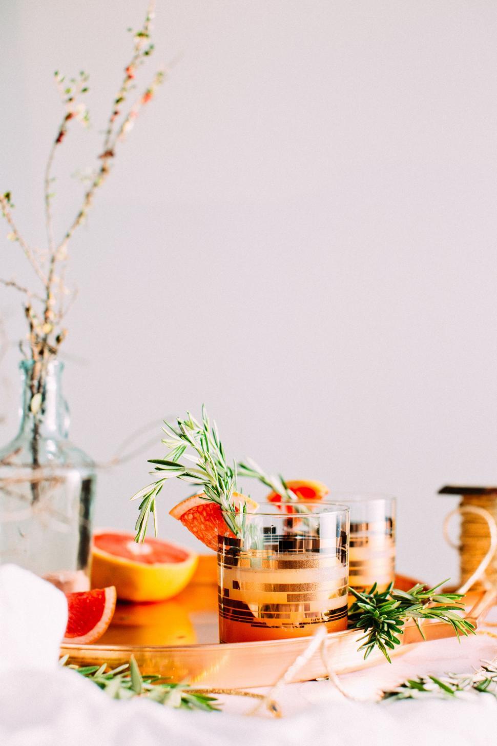 Free Image of Table With Oranges and Vase of Flowers 