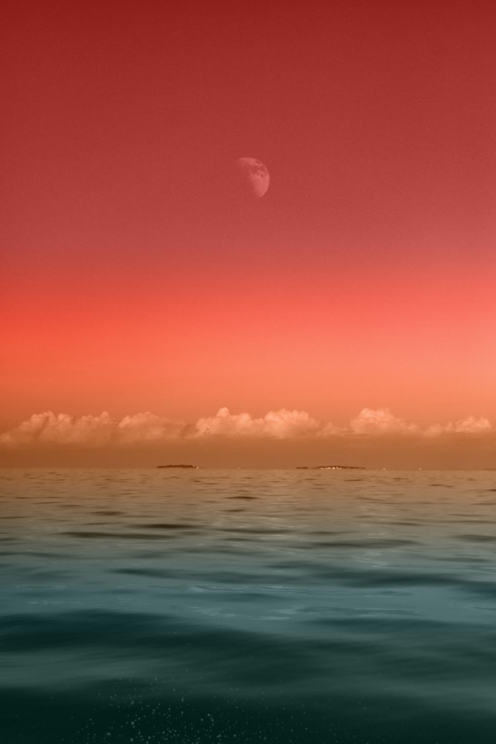 Free Image of Red Sky and Clouds Above Ocean 