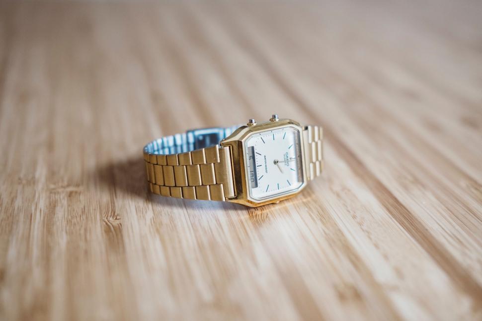 Free Image of Gold Watch on Wooden Surface 