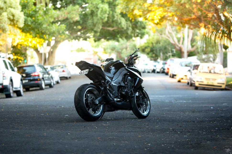Free Image of Black Motorcycle Parked on Side of Road 
