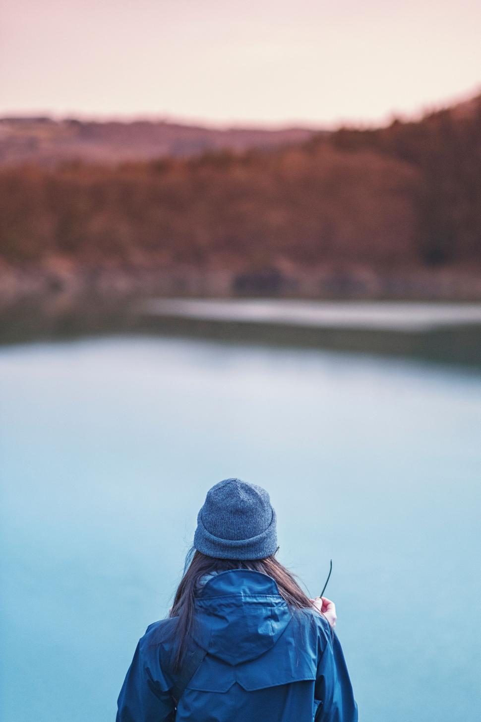 Free Image of Woman Standing in Front of Body of Water 