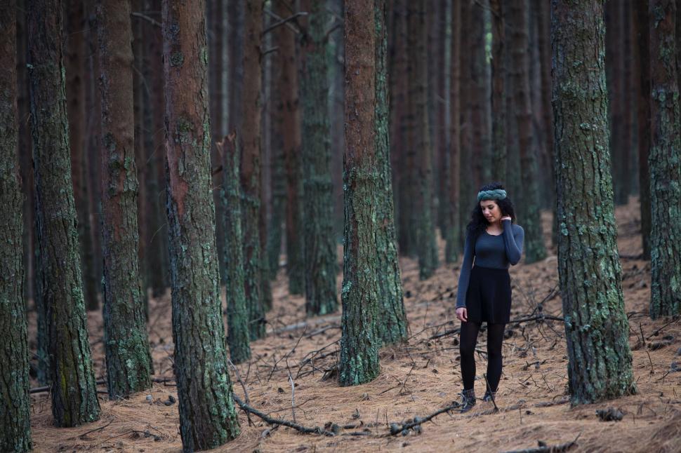 Free Image of Woman Standing in the Middle of a Forest 