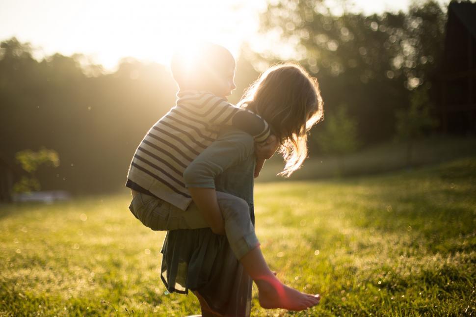 Free Image of Little Girl Holding Man in Field 