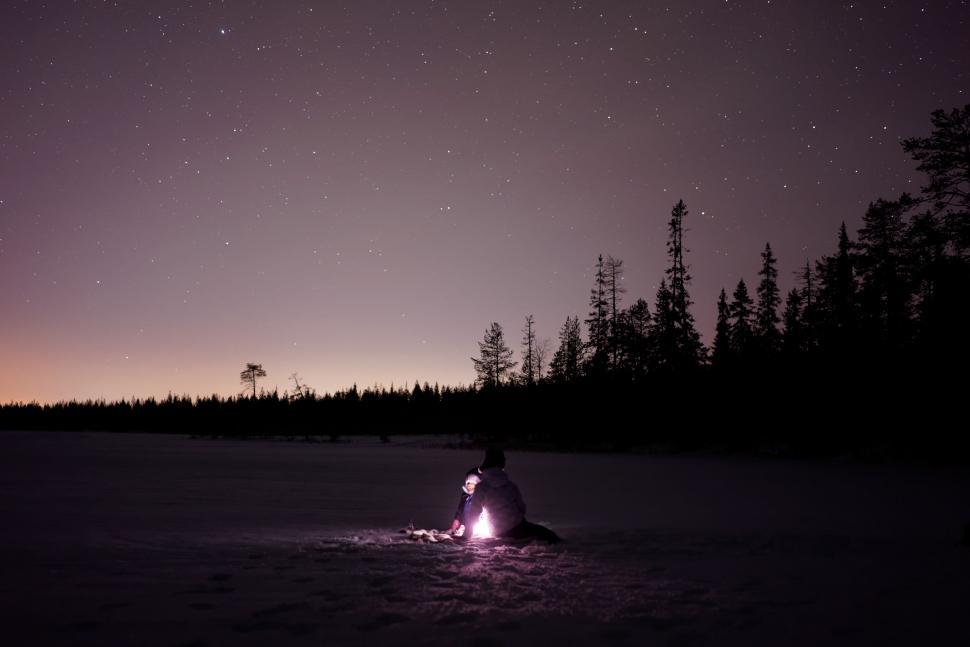 Free Image of Person Sitting in Snow at Night 