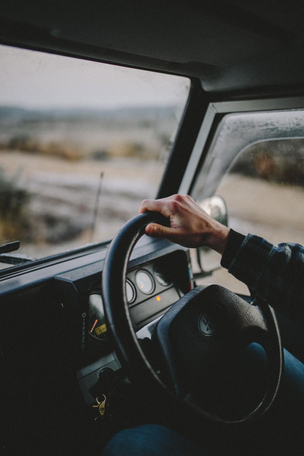 Free Image of Man Driving a Truck With a Steering Wheel 