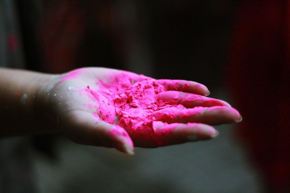 Free Image of Childs Hand Covered in Pink Powder 