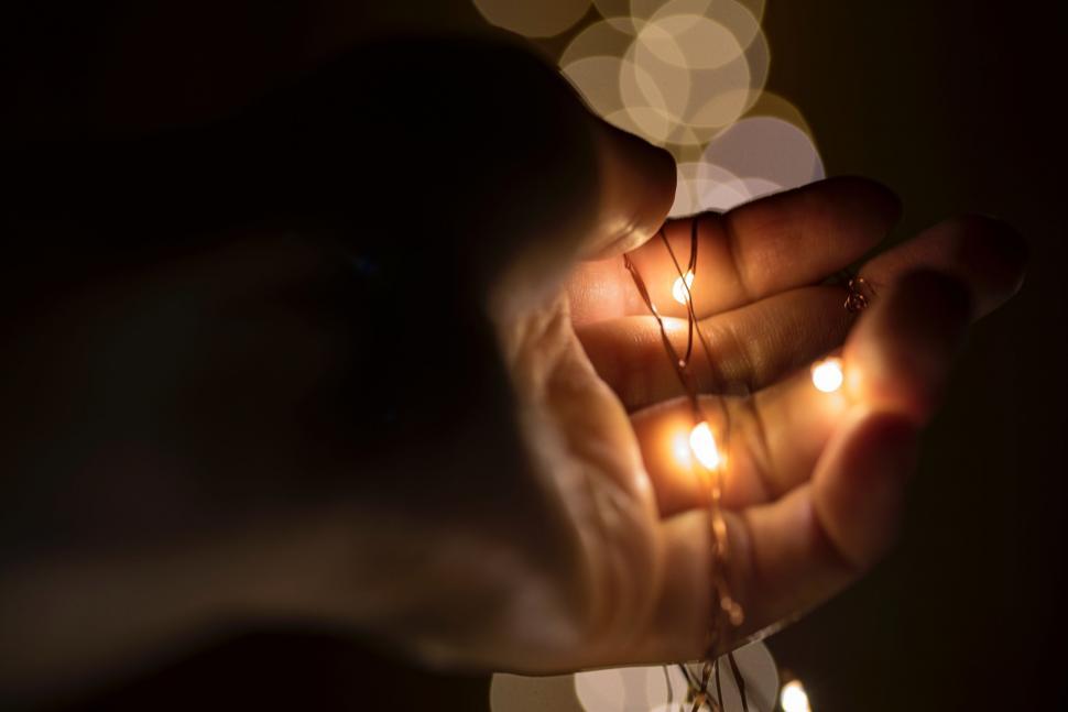 Free Image of Person Holding String of Lights 