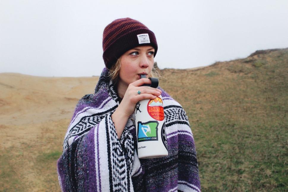 Free Image of Woman Holding Blanket and Bottle of Milk 