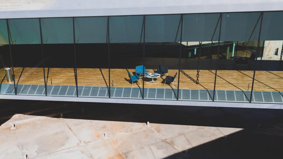 Free Image of Person Sitting on Bench in Front of Building 