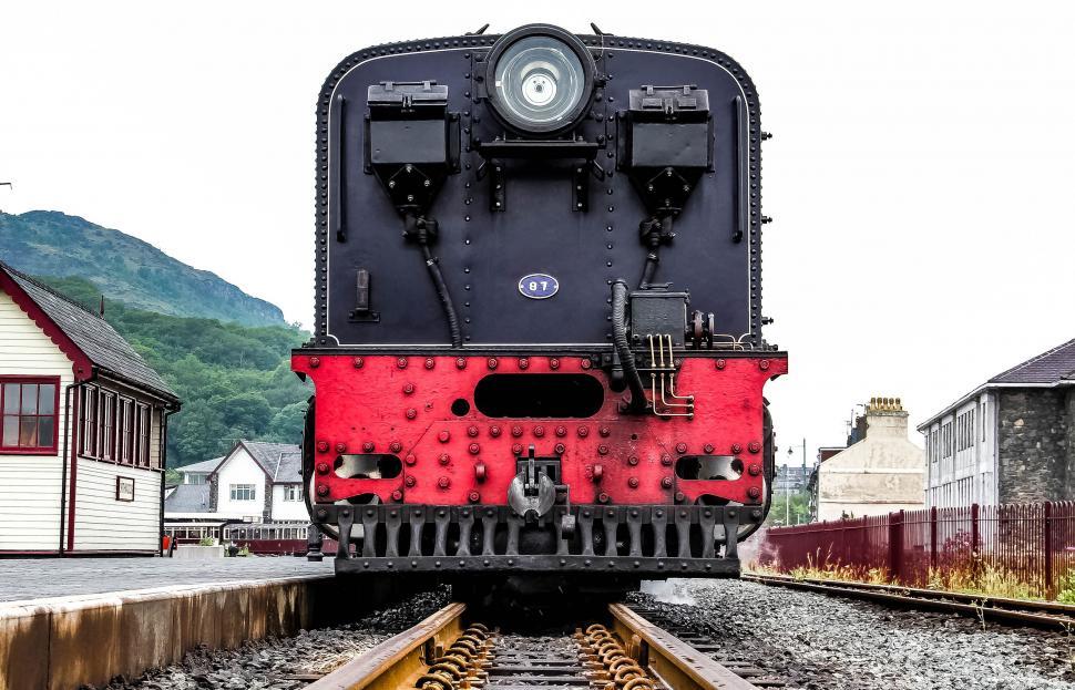 Free Image of Red and Black Train Travelling Down Train Tracks 