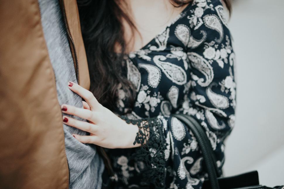 Free Image of Woman Holding a Purse and Posing 