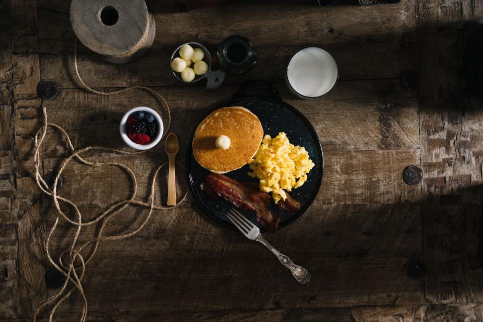 Free Image of Black Plate With Pancakes and Scrambled Eggs 