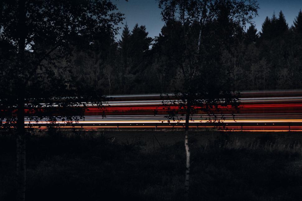 Free Image of Blurry Train Moving Through Forest 
