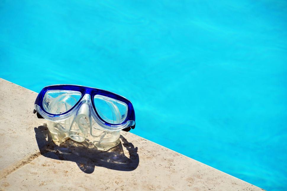 Free Image of Swimming Goggles on Edge of Swimming Pool 
