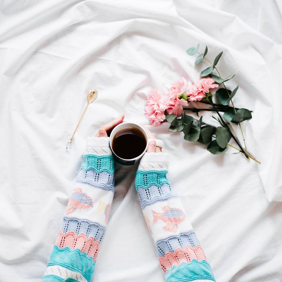 Free Image of Cup of Coffee on Bed Next to Socks 