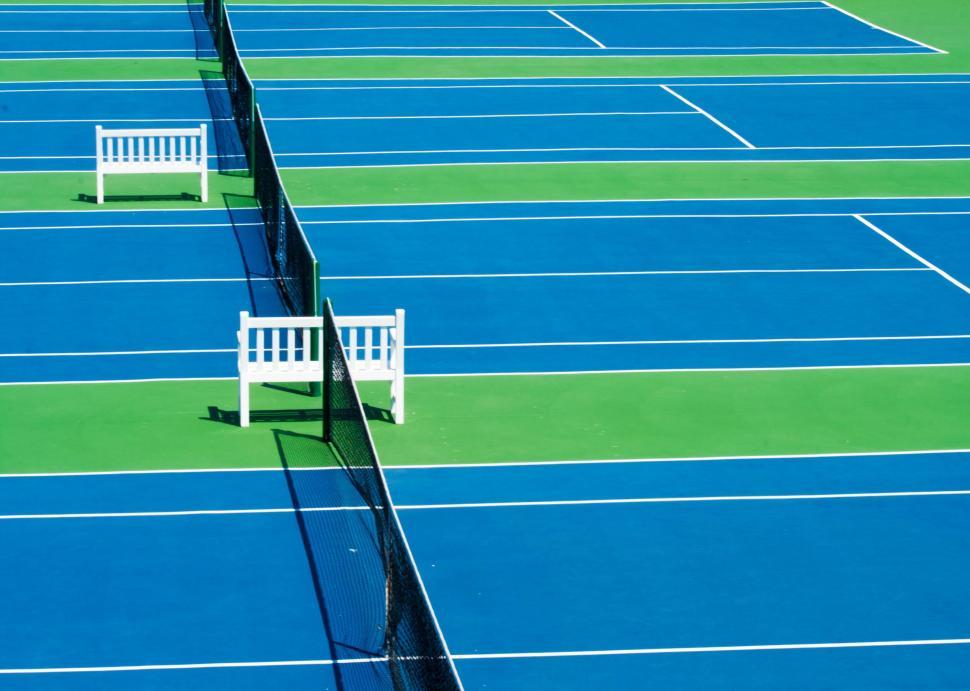 Free Image of Blue Tennis Court With Two White Benches 