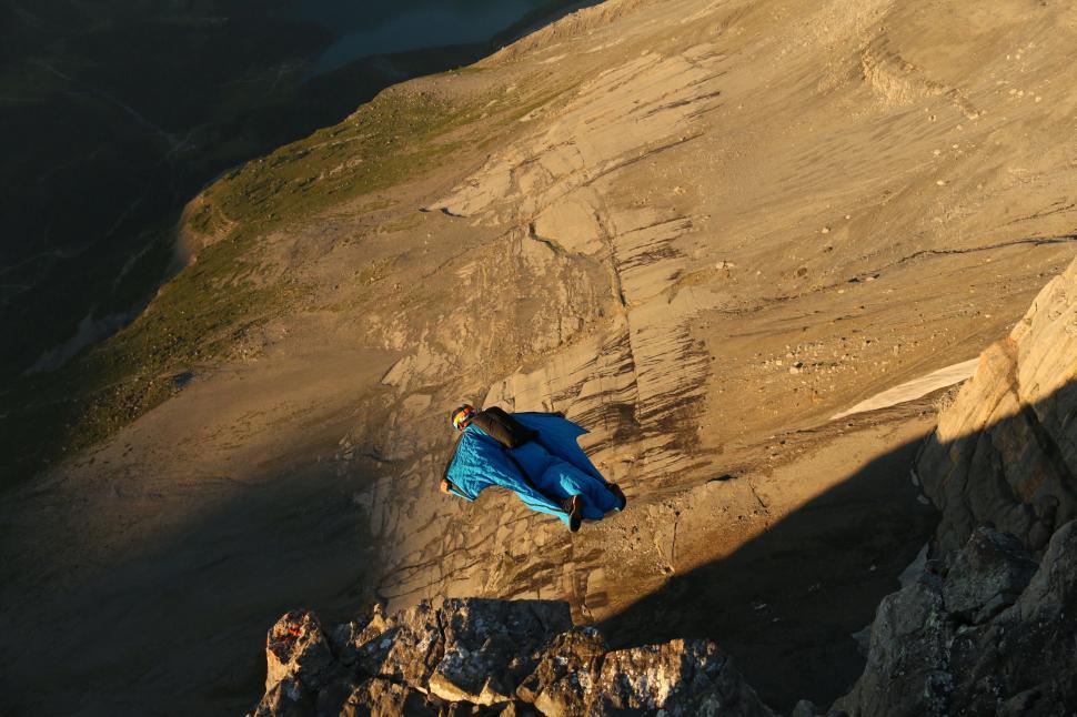 Free Image of Blue Umbrella Resting on Mountain Slope 