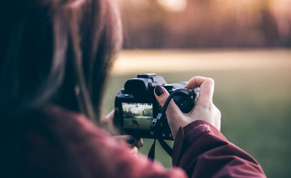 Free Image of Woman Capturing Field With Camera 