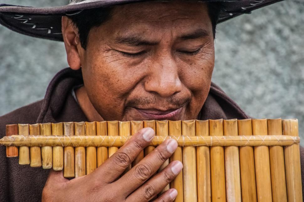 Free Image of Man Playing Bamboo Instrument 