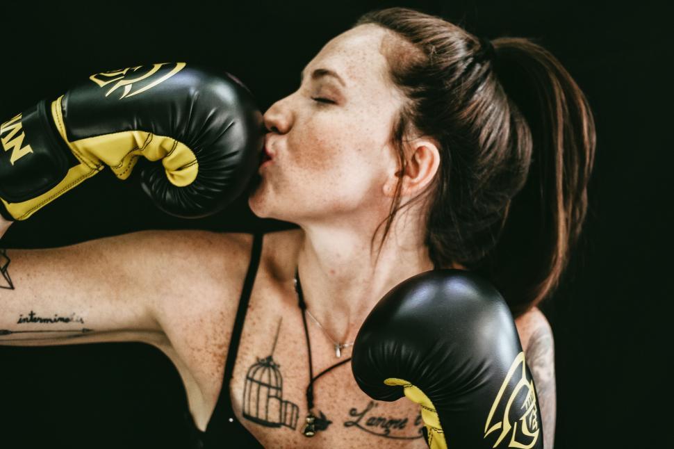 Free Image of Woman With Tattoos and Boxing Gloves 