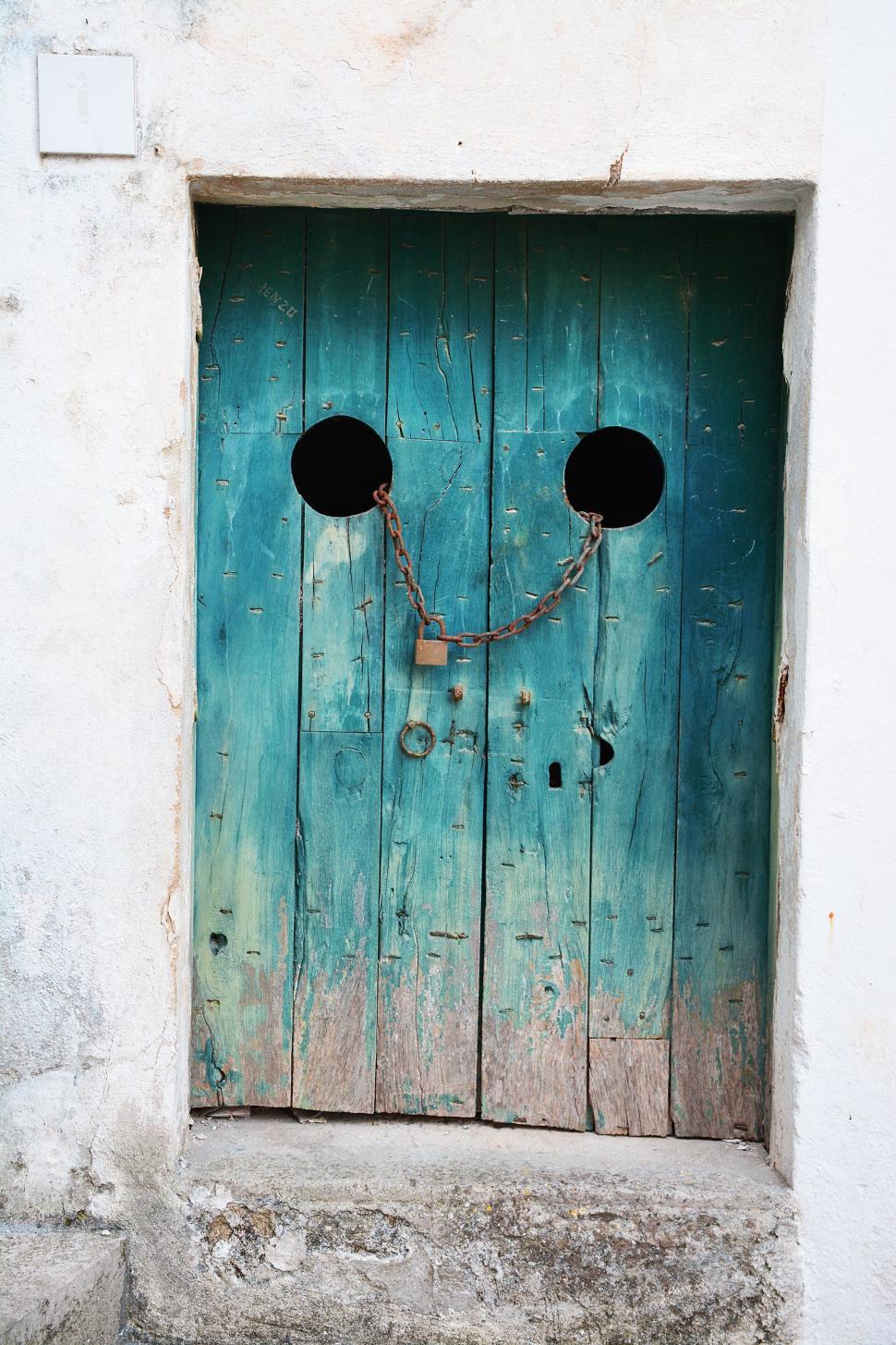 Free Image of Blue Door With Face Drawing 