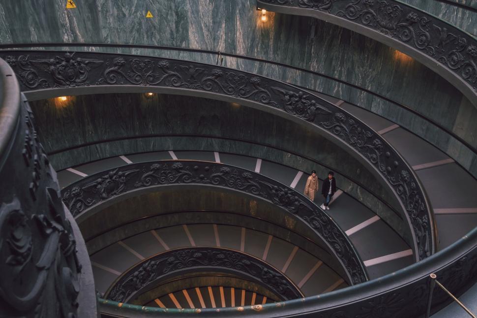 Free Image of Person Walking Up Spiral Staircase 