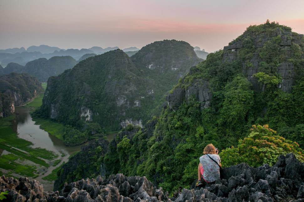 Free Image of Person Sitting on Mountain Overlooking Valley 