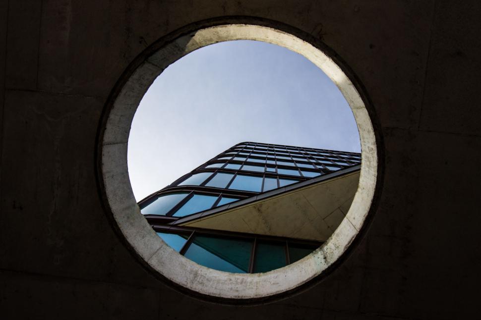 Free Image of Round Window Showing Building View 