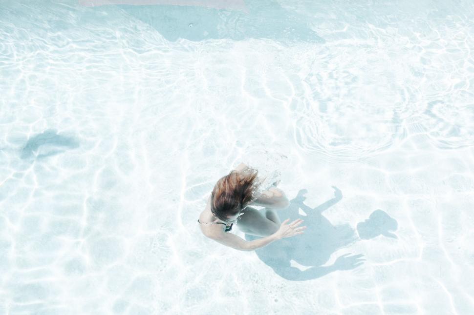 Free Image of Woman Swimming in Pool of Water 