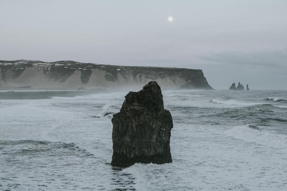 Free Image of Massive Rock Emerging From the Ocean 
