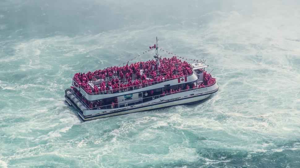 Free Image of Boat Full of People in the Middle of the Ocean 