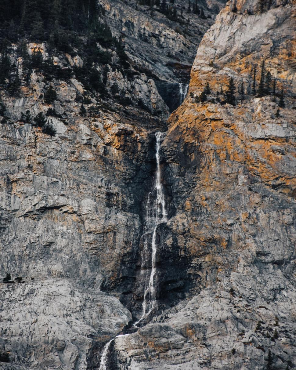 Free Image of A Waterfall Cascading in the Midst of a Mountain 