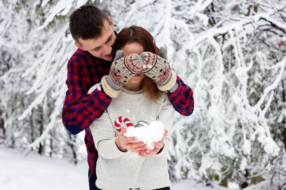Free Image of Man and Woman Holding Snowball 