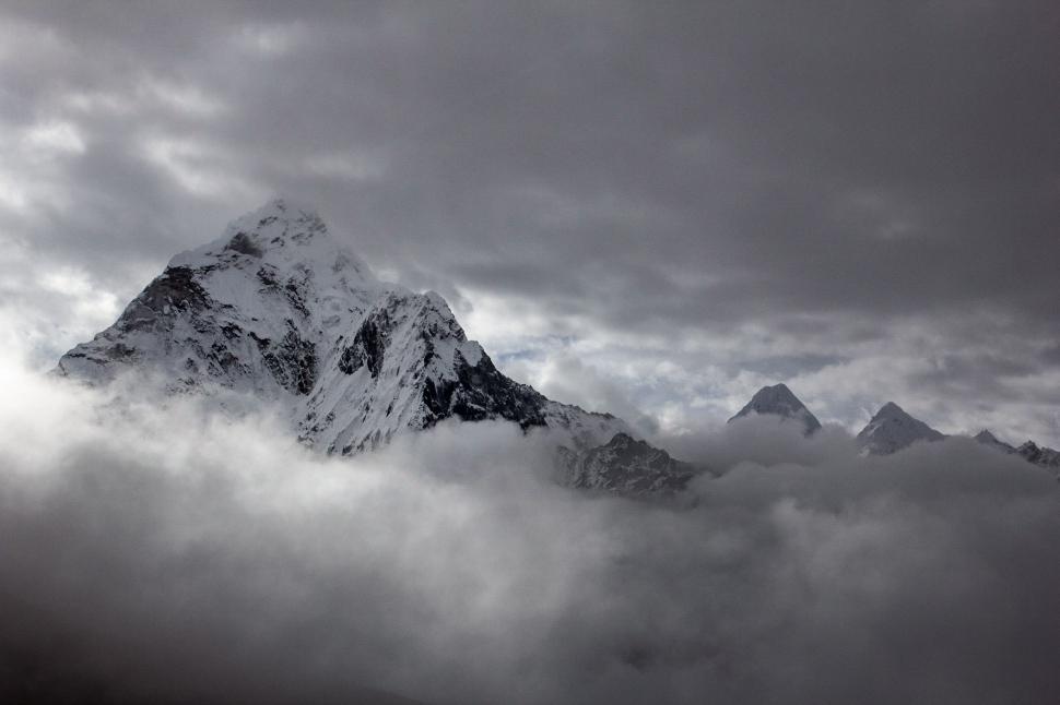 Free Image of Mountain Shrouded in Clouds Under Cloudy Sky 